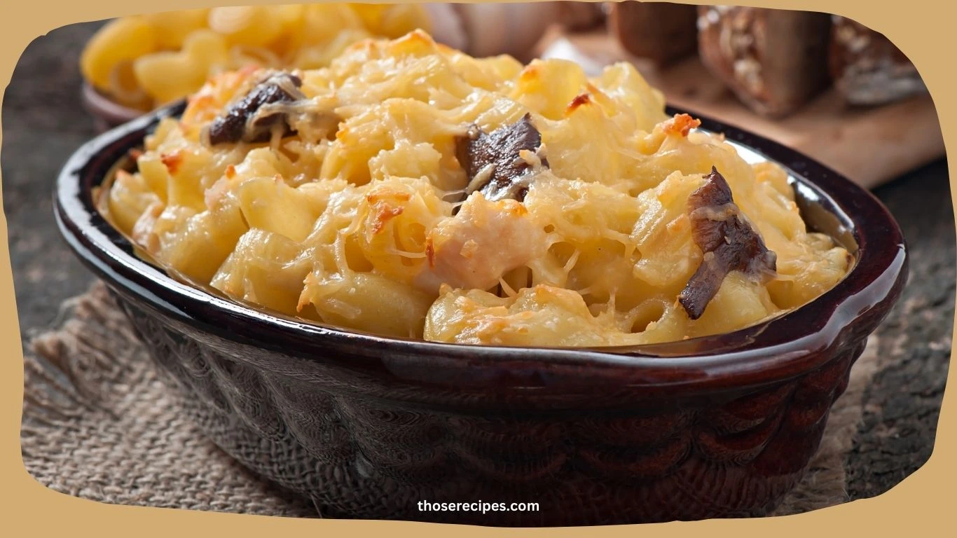 A serving of baked mac and cheese in a white dish with a golden crust.