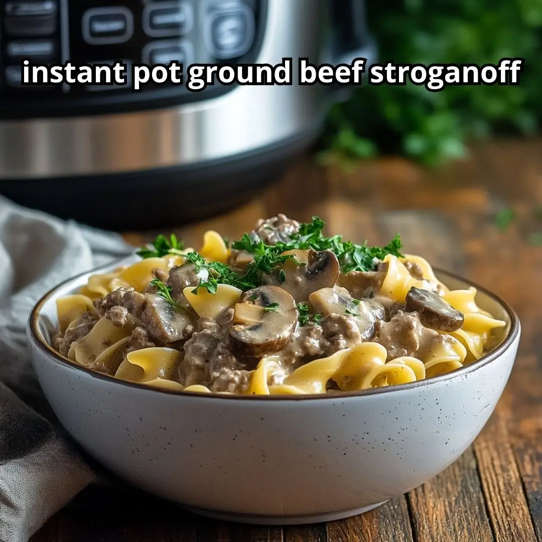 Creamy instant pot ground beef stroganoff with mushrooms and egg noodles served in a bowl next to an Instant Pot on a rustic wooden table.